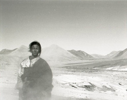 Nomadien shepherd in steam of Tibetan gusher